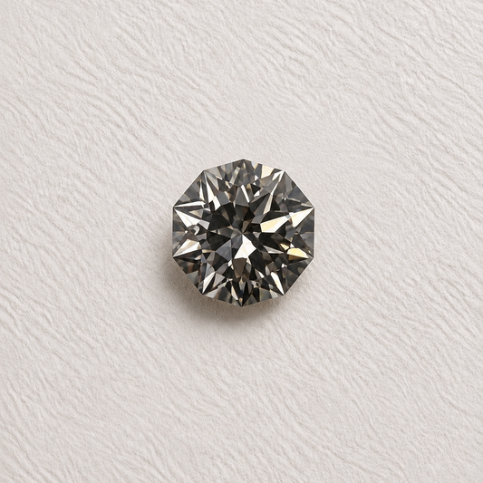A single round brilliant-cut lab grown diamond with a dark gray appearance, set against a textured off-white background.